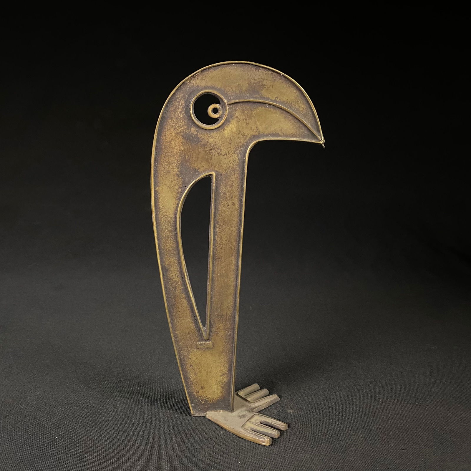 Korean Bronze Toucan or Parrot Decorative Figure: Korean Bronze Toucan or Parrot Decorative Figure. It is in good condition with an mild patina and a slight bow to its structure. There is a ringlet hanging from the tip of the beak, and it is has Kore