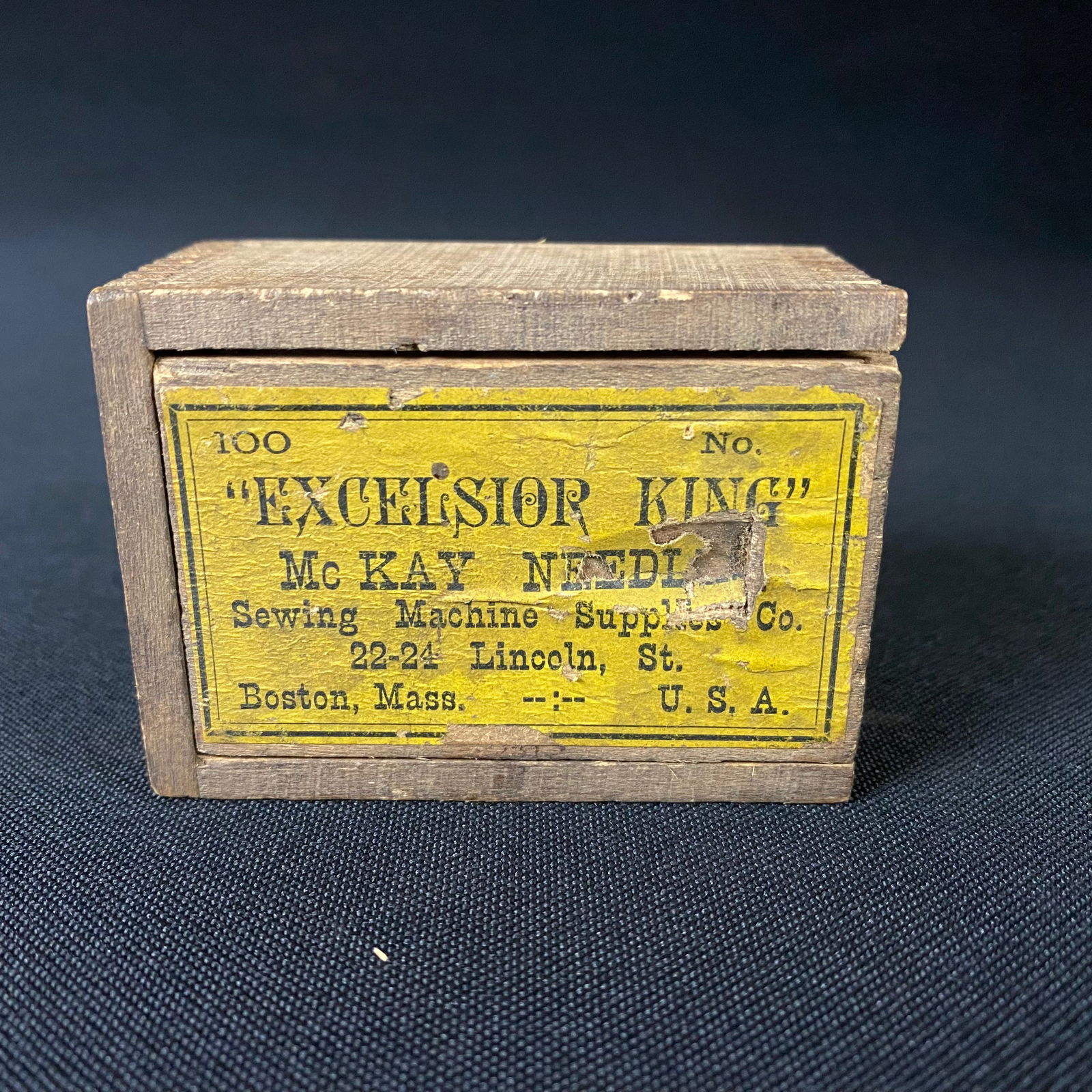 Antique Excelsior King Needles Box: Antique Excelsior King Needles Box. It is in good condition with moderate surface wear and some damage to the lid on the rabbited edge where it slides into the guide dado notch of the box, as well as