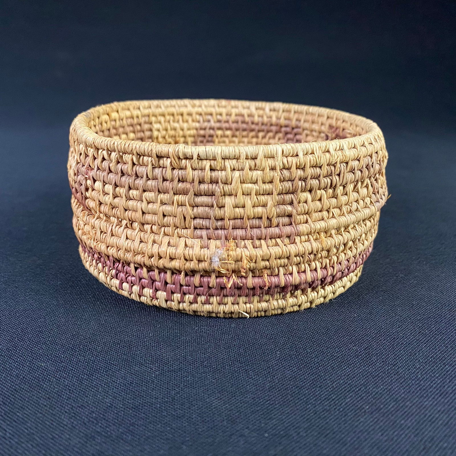 Vintage Arts and Crafts Hand Made Natural Fiber Basket: Hand Made Hemp Basket. It is in great condition with little fraying to the fibers. There is a small gap in the bottom of the basket where one row of the woven wrap settled into a position that allowed