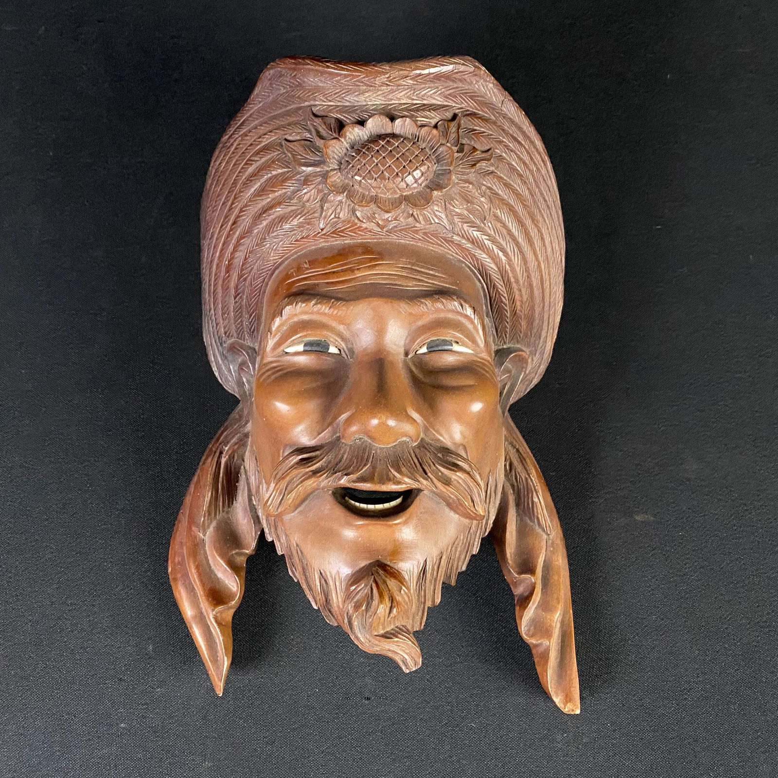 Vintage Hand Carved Chinese Portrait Wall Hanging: Vintage Hand Carved Chinese Portrait Wall Hanging. Circa Mid Century. It is carved out of a solid piece of hardwood, may be Cherry. It is a reddish-brown color, and has black and white inserts for the