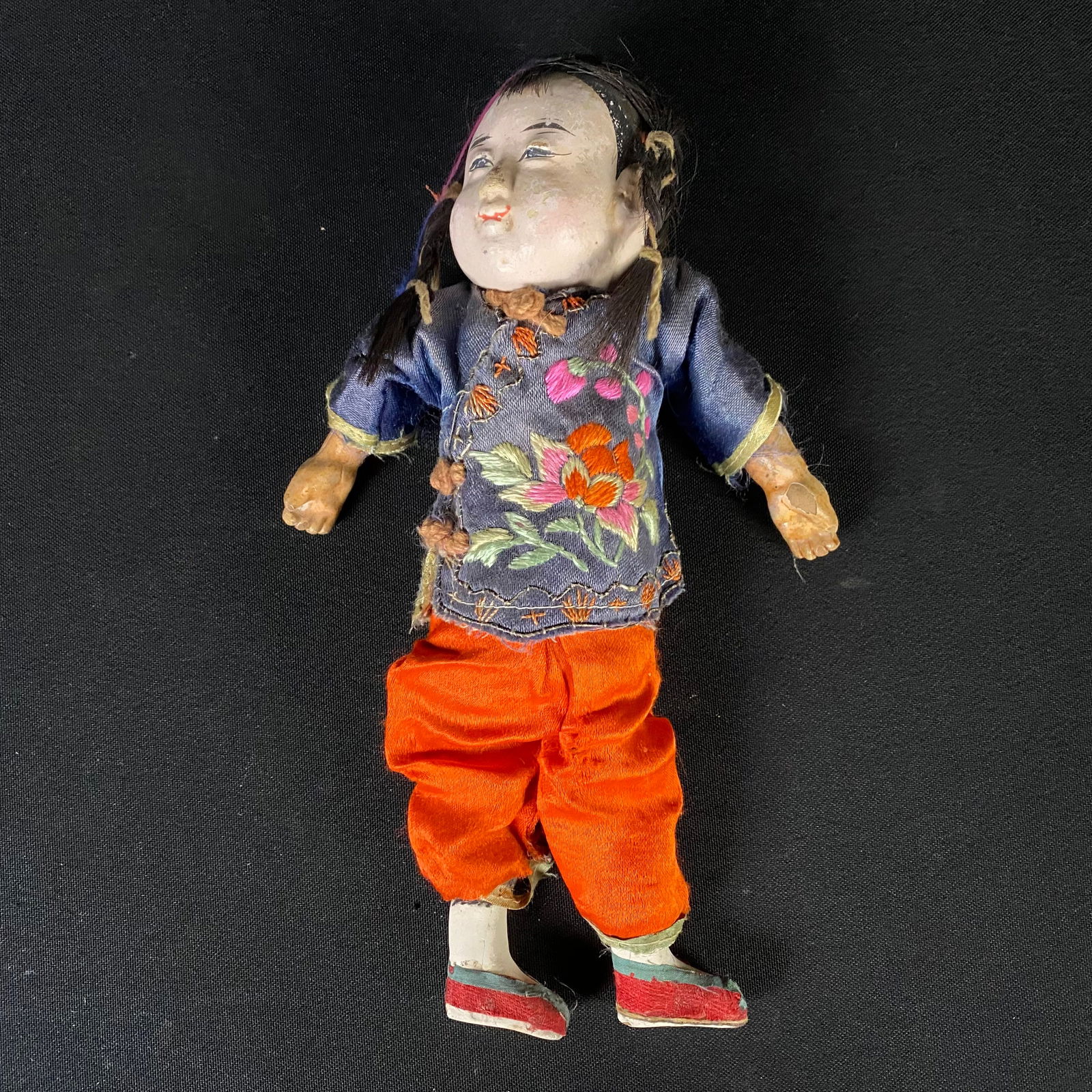 Antique Cloth Body Chinese Doll from the Early 1900s: Antique Cloth Body Chinese Doll from the Early 1900s. It is in good condition with mild to moderate wear including chipping to the plaster and paint on the paper limbs (primarily on the doll's left ar