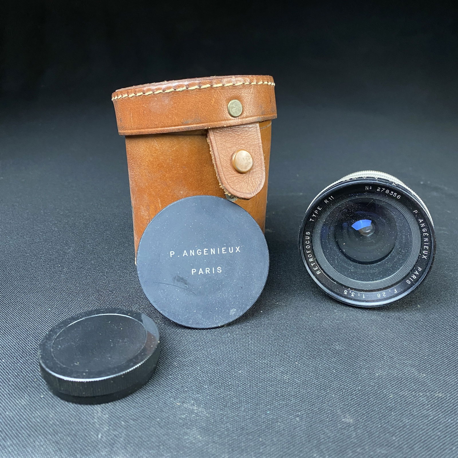 P.Angenieux Paris Retrofocus Type R11 No. 278356 Camera Lens: P.Angenieux Paris Retrofocus Type R11 No. 278356 Camera Lens. This lens has both caps and has been protected in a leather case.