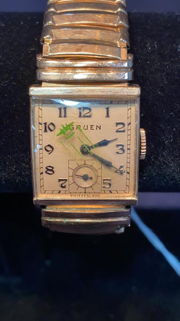 GRUEN 10KT GOLD FILLED WATCH W/PLANE DECORATION: PLANE DECORATION ON THE CRYSTAL OF THE WATCH