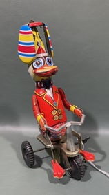 VINTAGE SCHYLLING DUCK ON A BIKE WIND UP TOY