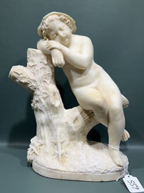 ALABASTER FIGURE OF A CHILD ON A TREE