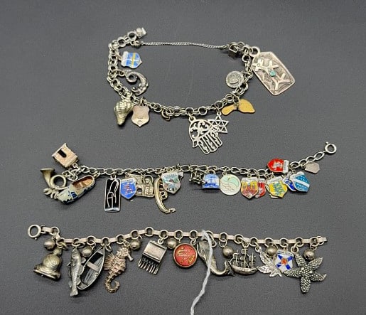 3 VARIOUS STERLING CHARM BRACELETS: 3.1 OZT