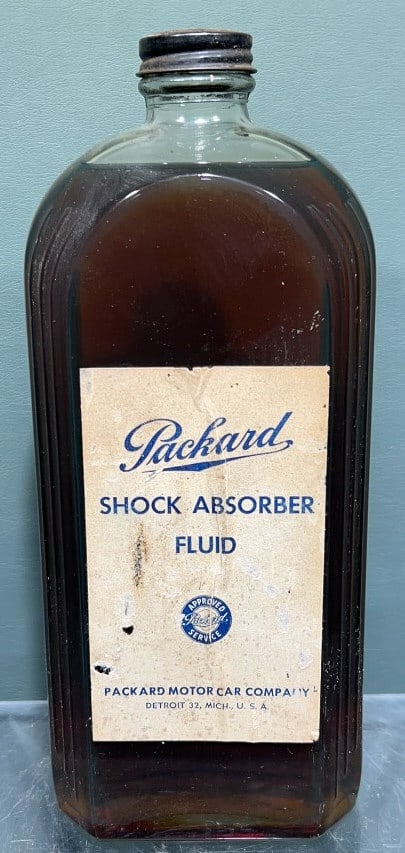 VINTAGE PACKARD SHOCK ABSORBER FLUID GLASS BOTTLE: 10" X 4-1/2" X 2-1/4"