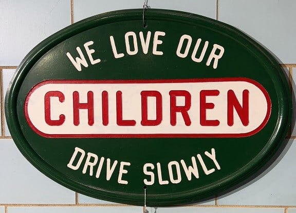 CAST IRON "WE LOVE OUR CHILDREN DRIVE SLOW" SIGN (1 of 6)