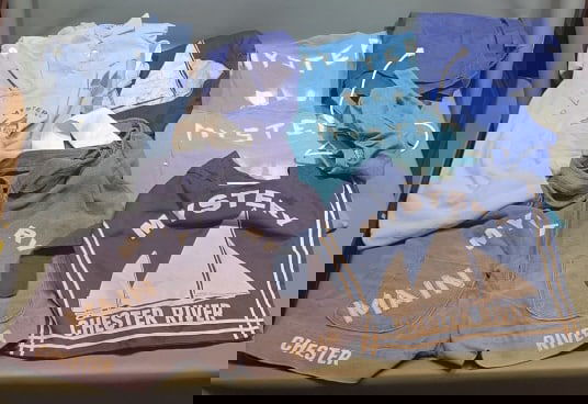 CHESTER RIVER LOG CANOE RACE APRON, T-SHIRTS, ETC.: From local Kent County estate. Clothing worn in Chester River log canoe races on the Mystery. 11 pieces total. Includes a stitched apron, stenciled t-shirts, & more. Some with stains. Shirt measures 2