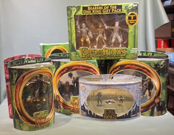 (7) SEALED LORD OF THE RINGS TOYBIZ ACTION FIGURES: All but one are Fellowship of the Ring & one is The Two Towers. Largest box measures 12" in width and 12" in height.