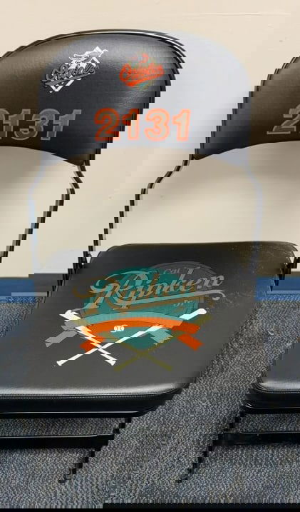 CAL RIPKEN JR. COMMEMORATIVE METAL FOLDING CHAIR: Used on the field for Cal Ripken's 2131 event. Measures 18 1/4" in width and 32" in height.
