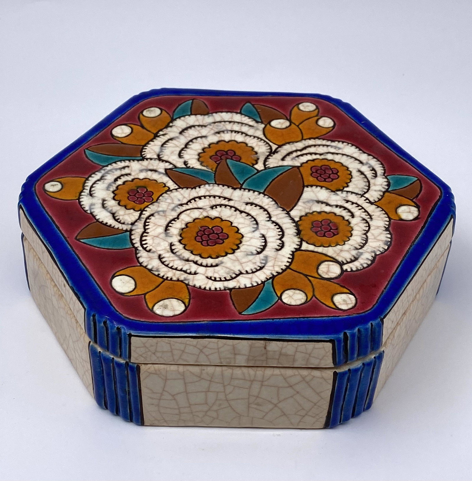Hexagonal Art Deco Longwy jewelry box: This art deco lidded vanity container features a very unique eye catching art nouveau design. The backdrop for the majority of the piece is the signature Longwy crackled finish in a creamy beige hue a
