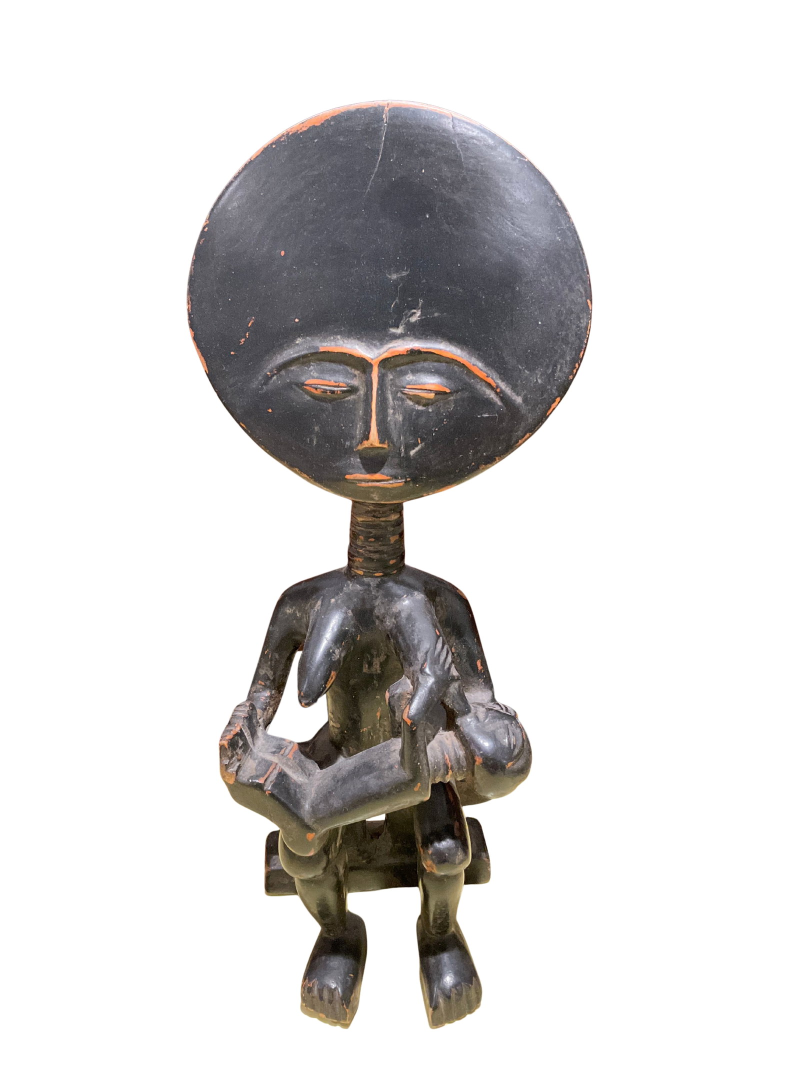 Wooden African Mother and Child Sculpture: This sculpture depicts a stylized African mother holding a child, likely carved with traditional techniques. The piece is crafted from wood and finished with a dark stain, showcasing traditional Afric