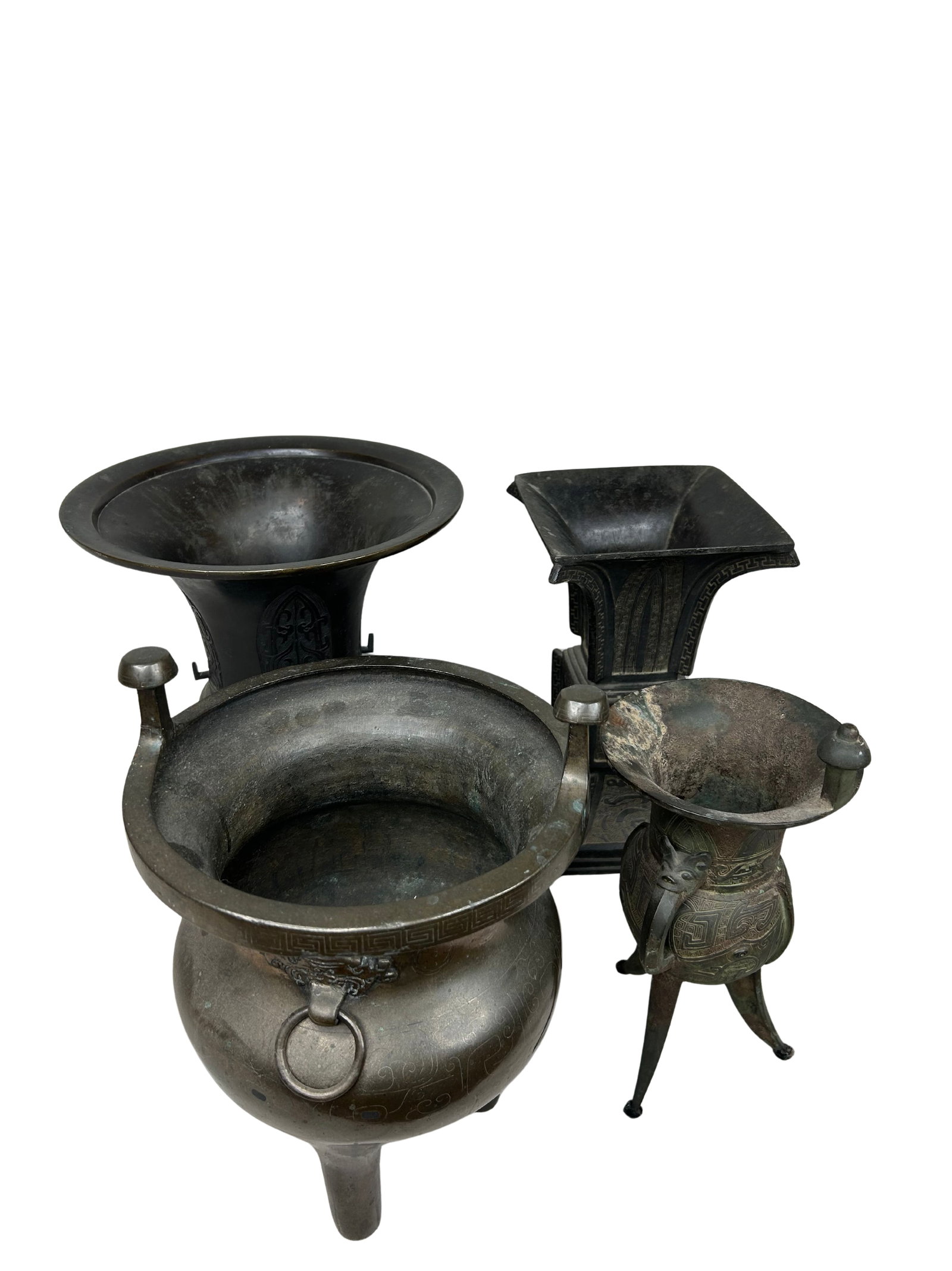 Set of Four Vintage Iron East Asian Style Vases: This lot of four iron vases presents a visually captivating ensemble, each piece exhibiting a rich antique aesthetic. The vases display an appealing dark patina, likely developed over years of handlin