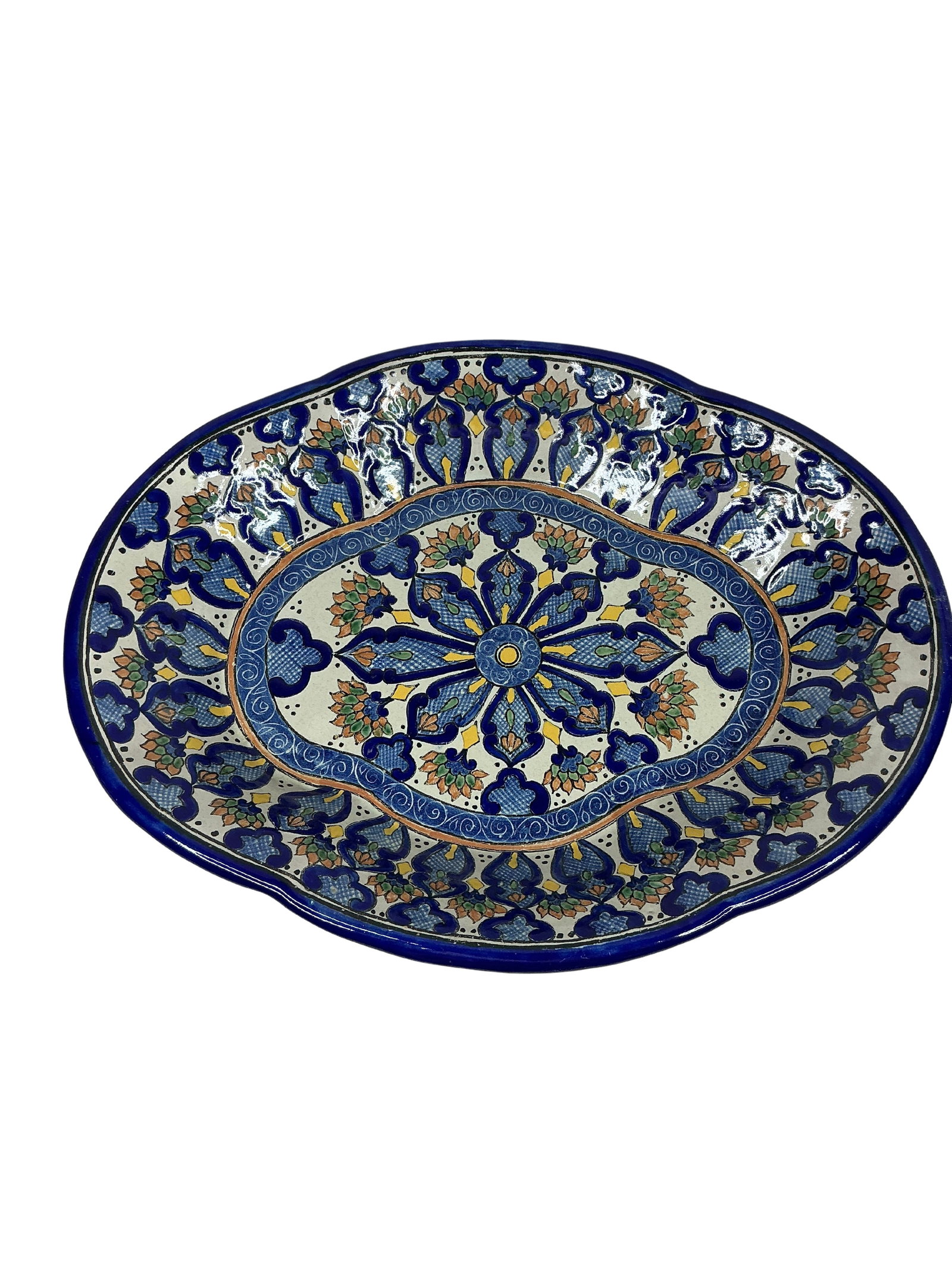 Hand-Painted Mexican Talavera Scalloped Platter: This decorative Talavera platter features a distinctive scalloped shape and beautiful, intricate hand-painted designs typical of Mexican Talavera pottery. The colorful patterns are a vibrant mix of