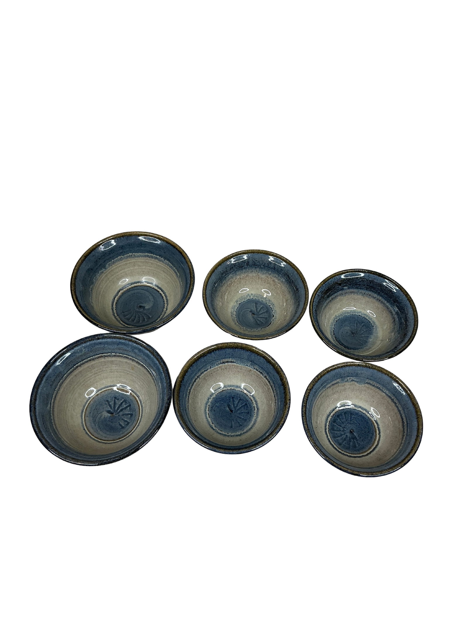 Artisan Blue and Oatmeal Stackable Ceramic Bowl Set with Artist Mark, Set of Six: This set of six stackable ceramic bowls features a harmonious blend of blue and oatmeal tones, radiating an understated elegance ideal for both display and daily use. Crafted with an artisanal touch, 