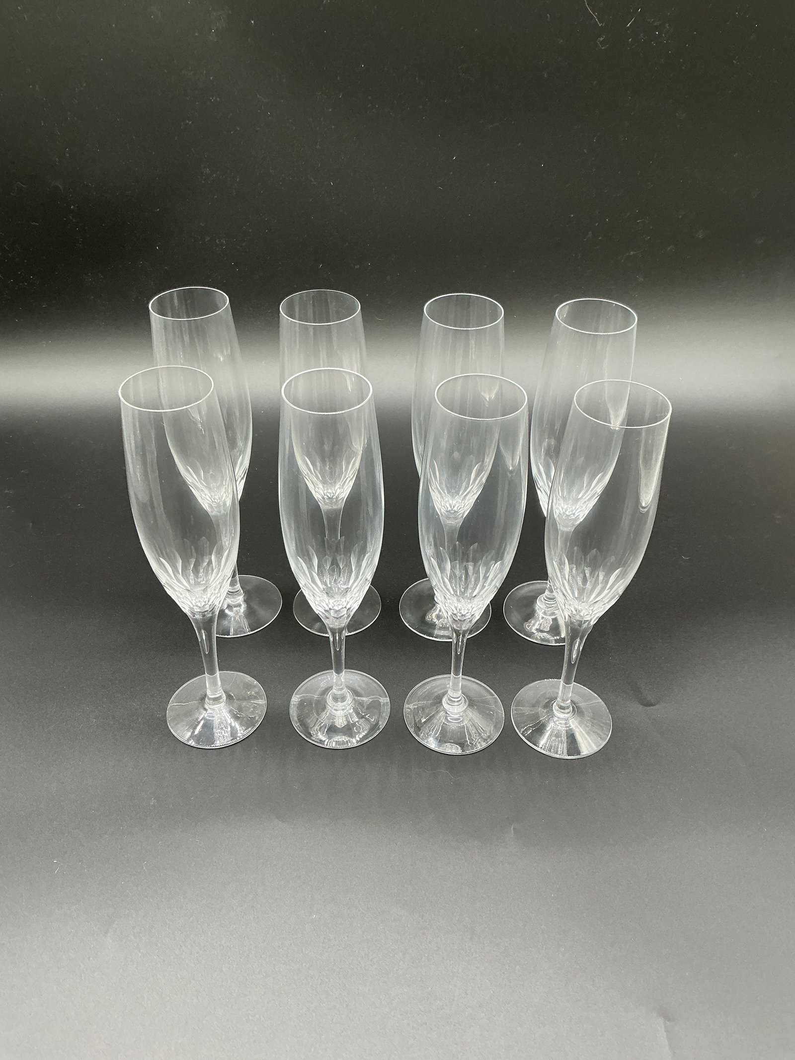 Orrefors Set of 8 Champagne Flutes, Sweden - Cut Glass Design: This exquisite set of eight champagne flutes from Orrefors, a prestigious Swedish glassmaker, embodies the hallmark elegance of Nordic design. Each flute features an elongated, gently tapering bowl th