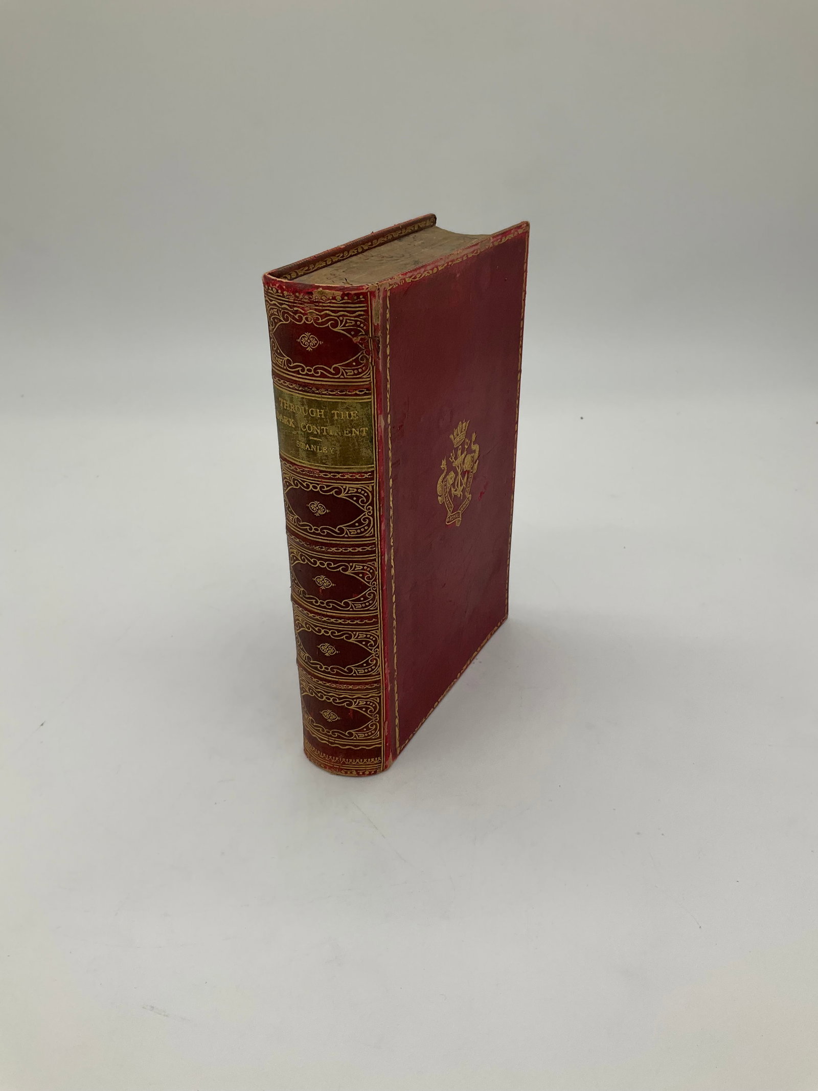 Dark continent book: This is an 1890 edition of 'Through the Dark Continent' by Henry M. Stanley, a seminal work documenting his exploration of Africa. Bound in a striking red hardcover with gilt embellishments, this volu
