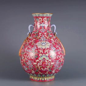 A ROUGE RED-GROUND FAMILLE ROSE 'SCROLLING LOTUS' RUYI PIPA VASE