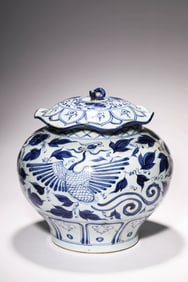 A BLUE AND WHITE 'PHOENIX AND FLOWER' LIDDED JAR WITH LOTUS LEAF COVER