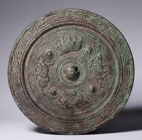 A BRONZE 'FOUR BEASTS' MIRROR