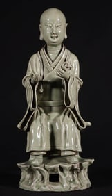 A SECRET-COLOR CELADON 'LUOHAN' FIGURE