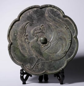 A BRONZE 'PHOENIX' MIRROR IN FLOWER SHAPE