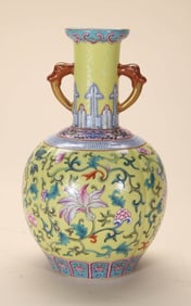 A YELLOW-GROUND FAMILLE ROSE 'SCROLLING FLOWER' DOUBLE-HANDLED VASE