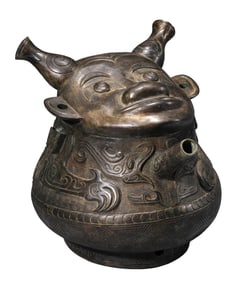 A BRONZE 'DRAGON-BODY WITH HUMAN FACE' HE VESSEL