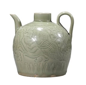 A YAOZHOU TYPE CARVED 'PHOENIX AMONG FLOWERS' EWER