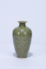 A CELADON CARVED 'INTERLOCKING FLOWERS' VASE
