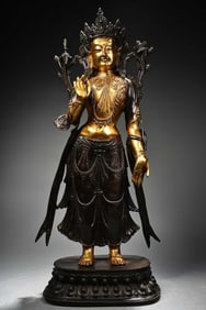 A GILT-BRONZE TIBETAN GREEN TARA WITH HIGH-RELIEF CARVING