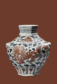 A BLUE AND WHITE WITH UNDERGLAZE-RED 'ANIMAL HEADS' JAR