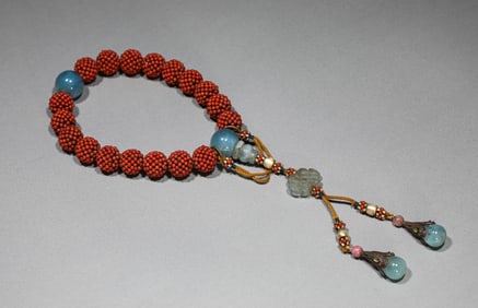 AN AGARWOOD EIGHTEEN-BEAD BRACELET