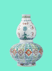 A DOUCAI 'AUSPICIOUS BEAST AND FLORAL' GOURD SHAPED VASE