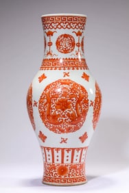 AN IRON-RED 'DRAGON, BAT AND SHOU' OLIVE VASE