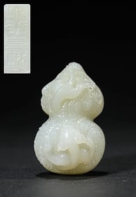 A JADE 'CHILONG, BAT AND DEER' CARVING