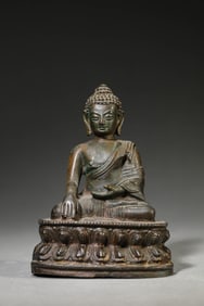 A BRONZE SHAKYAMUNI BUDDHA