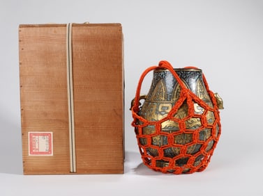 A BRONZE-EFFECT GLAZE DOVE-HANDLED VASE