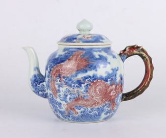 A BLUE AND WHITE WITH UNDERGLAZED RED 'DRAGONS IN WAVES' TEAPOT