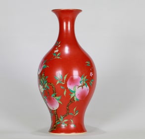 A CORAL-RED GROUND FAMILLE ROSE 'PEACHES OF SHOU' VASE