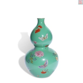 A GREEN-GROUND FAMILLE ROSE 'FLOWERS AND BUTTERFLIES' GOURD-SHAPED VASE