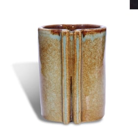 A BROWN-GLAZED SCROLL-SHAPED BRUSH POT
