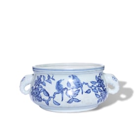 A BLUE AND WHITE 'FLOWERS AND BIRDS' ELEPHANT-HANDLED CENSER