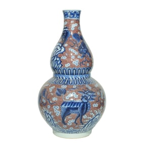 A UNDERGLAZE RED WITH BLUE AND WHITE 'AUSPICIOUS BEASTS' GOURD-SHAPED VASE