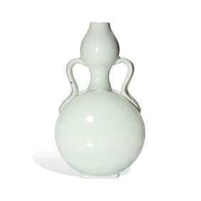 A WHITE-GLAZED RIBBON-HANDLED GOURD-SHAPED VASE