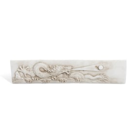A CARVED 'DRAGON IN WAVES' PAPERWEIGHT