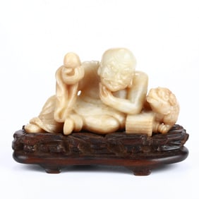 A HOTAN JADE 'ARHAT' FIGURE