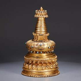 A GILT-BRONZE STUPA
