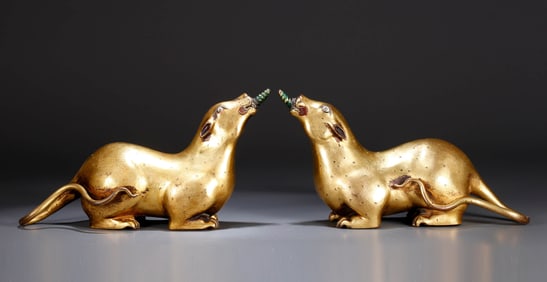 A PAIR OF GILT-BRONZE 'TREASURE-SPITTING MONGOOSE'